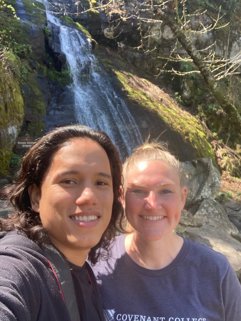 Abigail and her husband hiking to a waterfall as a tech-free family activities option