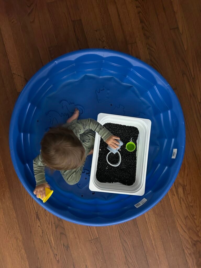 Another easy Montessori for Toddlers activity. My son practicing pouring more black beans using small containers. 